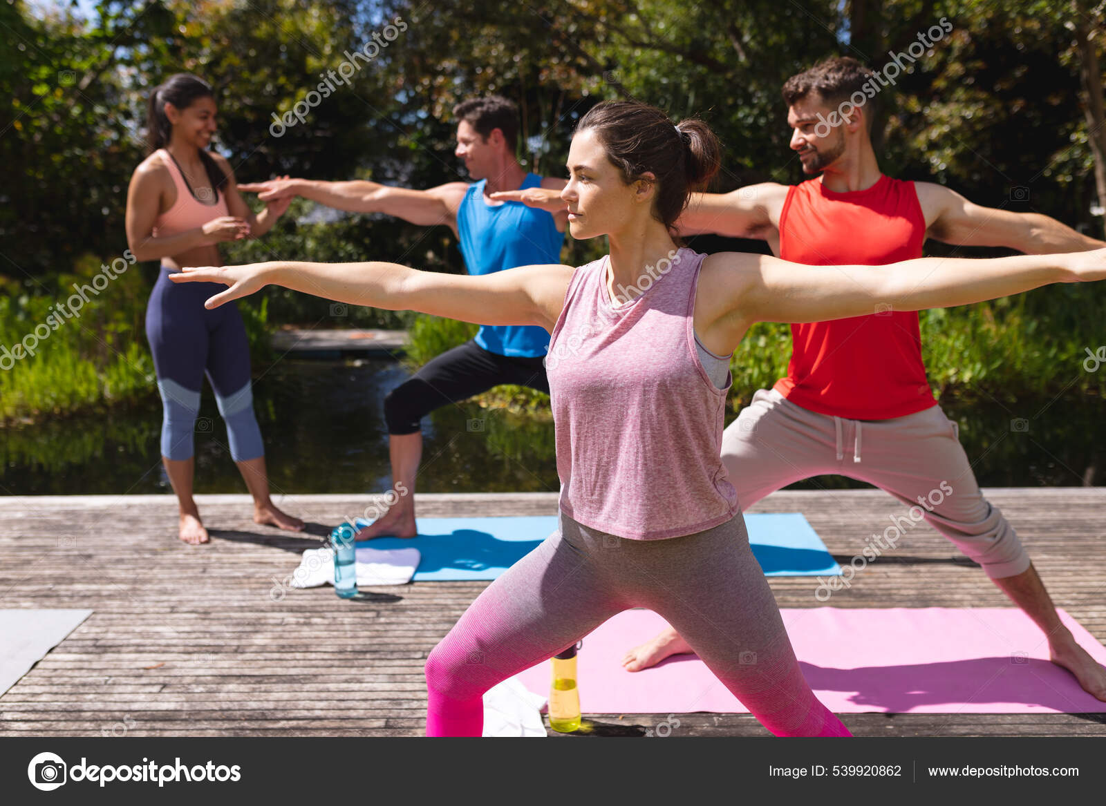Female Yoga Instructor Assisting Men Woman Exercise Session Park Healthy  fotos, imagens de © Wavebreakmedia #539920862