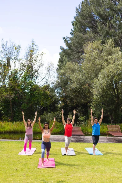 Female Instructor Teaching Yoga Pose Men Woman Public Park Healthy — стоковое фото