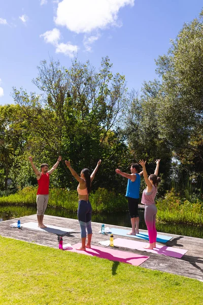 Male Instructor Teaching Yoga Man Women Exercise Session Park Healthy — стоковое фото