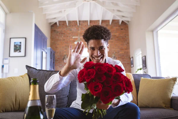 Portrait Happy Young Man Holding Rose Bouquet Waving Virtual Date — стоковое фото