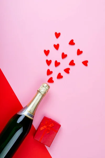 Láhev Šampaňského Stříkající Červené Srdce Tvary Dárkové Krabice Růžovém Pozadí — Stock fotografie