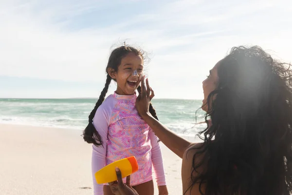 Cheerful Biracial Girl Looking Mother Applying Sunblock Lotion Her Nose — Stock Photo, Image