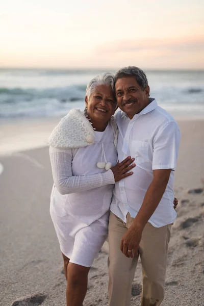 Portrait Smiling Senior Biracial Couple Embracing Beach Sky Sunset Lifestyle — Stock Photo, Image