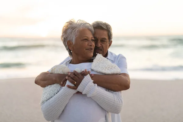 Affectionate Senior Biracial Man Embracing Woman While Standing Beach Sunset — Stock Photo, Image