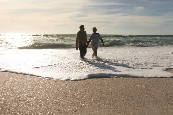 Happy Senior Multiracial Couple Enjoying Retirement Waves Shore Beach Sky — Stock Photo, Image