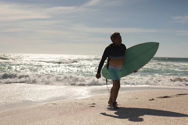 Dwurasowy Starszy Człowiek Niosący Deskę Surfingową Powracającą Surfingu Falach Morskich — Zdjęcie stockowe