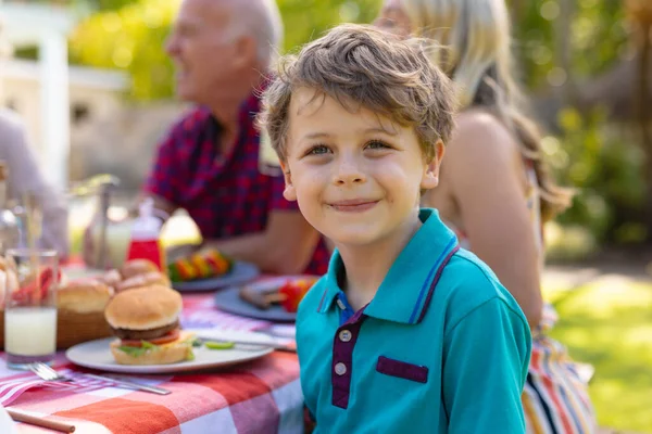 Retrato Niño Caucásico Sonriente Sentado Junto Con Familia Mesa Jardín —  Fotos de Stock