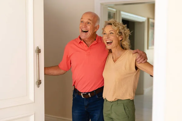 Sorprendida Pareja Ancianos Caucásicos Sonriendo Abrir Puerta Principal Casa Concepto — Foto de Stock