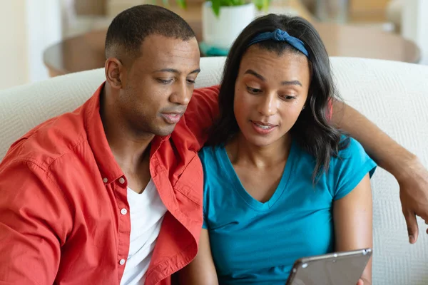非洲裔美国女人和坐在她身边的男朋友分享平板电脑 融合和技术概念 — 图库照片
