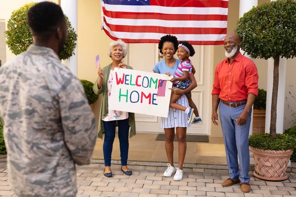 Χαρούμενη Αφροαμερικάνικη Οικογένεια Πλακάτ Που Καλωσορίζει Στρατιώτη Στην Είσοδο Του — Φωτογραφία Αρχείου
