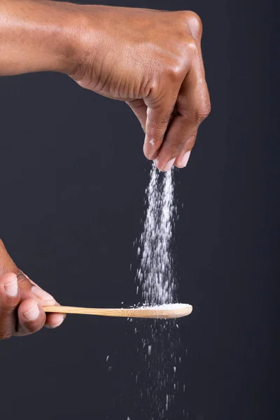Close African American Man Hand Sprinkling Seasoning Wooden Spoon Black — Stock Photo, Image