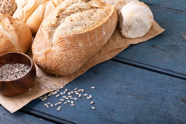 Close Vários Pães Sementes Tigela Papel Cera Marrom Mesa Alimentos — Fotografia de Stock