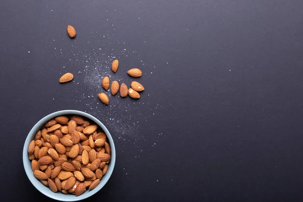 Diretamente Acima Tiro Amêndoas Boliche Com Sal Fundo Preto Alimentos — Fotografia de Stock