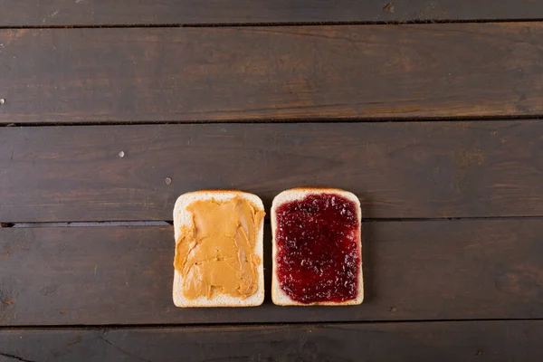 Blick Auf Brotscheiben Mit Erdnussbutter Und Marmeladen Auf Einem Holztisch — Stockfoto