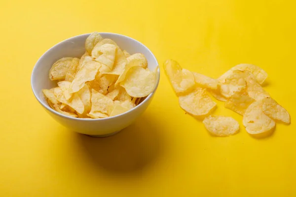 Close Potato Chips Bowl Yellow Background Unaltered Unhealthy Food Shadow — Stock Photo, Image