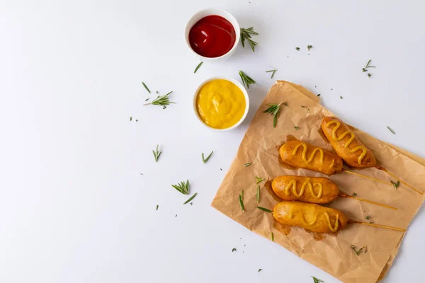 Corn Dogs Rosemary Paper Bag Mustered Tomato Sauces White Background — Stock Photo, Image