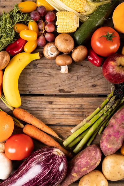 木製のテーブルの上に作られた空のハート型の様々な野菜や果物の直接上記のショット 変化のない 変化のない 健康的な食べ物 生の食べ物 有機的な概念 — ストック写真