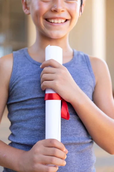 Midsection Smiling Caucasian Elementary Schoolboy Holding Degree Certificate Inalterado Imitación — Foto de Stock