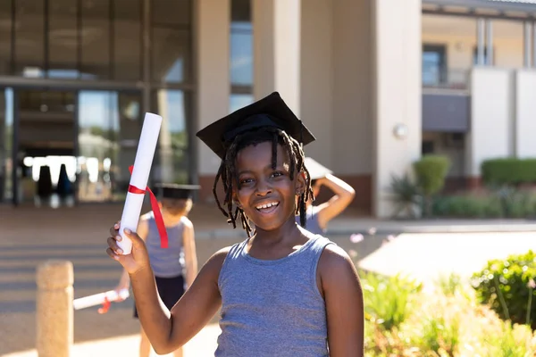 Portrait Smiling African American Elementary Schoolboy Wearing Mortarboard Showing Degree — Stock Photo, Image