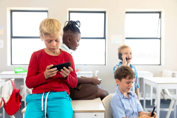 Escolas Primárias Multirraciais Usando Smartphone Enquanto Relaxa Sala Aula Durante — Fotografia de Stock