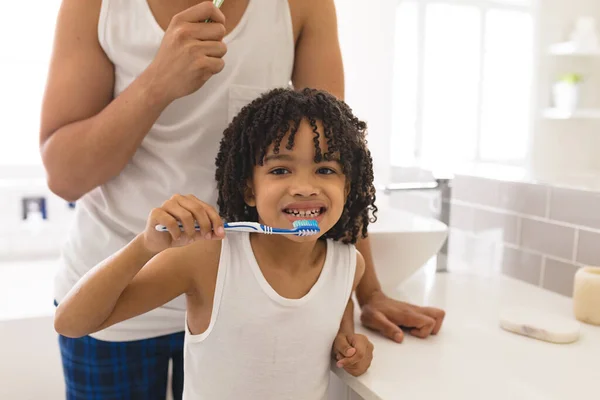 Portrait Hispanic Boy Brushing Teeth Father Bathroom Home Unaltered Family — Stock Photo, Image