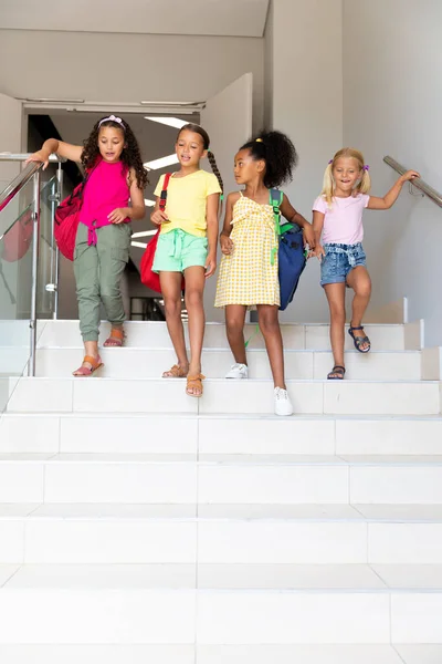 Full Length Multiracial Elementary Schoolgirls Backpacks Steps School Building Unaltered — Stock Photo, Image