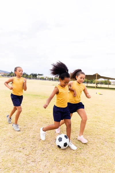Full Length Multiracial Elementary Schoolgirls Playing Soccer School Ground Sky — Stock Photo, Image