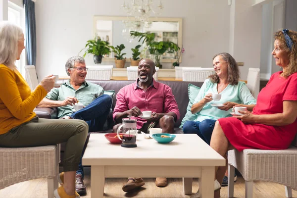 快乐的多种族老年男女朋友边聊天边在家喝咖啡 不变的生活方式 社交聚会 聚会和休闲 — 图库照片