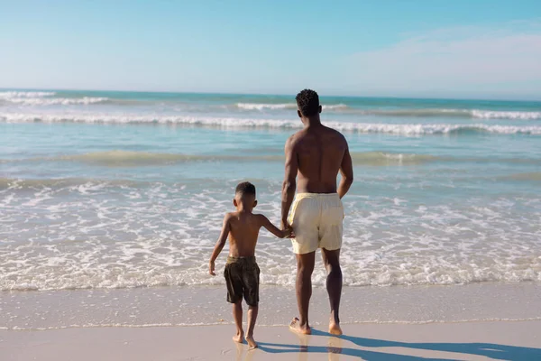 Rear View African American Shirtless Young Man Holding Son Hands — Stock Photo, Image