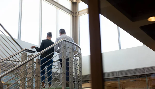 Low Angle View Caucasian Colleagues Discussing While Moving Staircase Modern — Stock Photo, Image