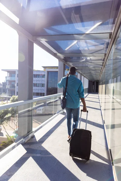 Rear View African American Businessman Walking Luggage Corridor Airport Sunny — Stock Photo, Image