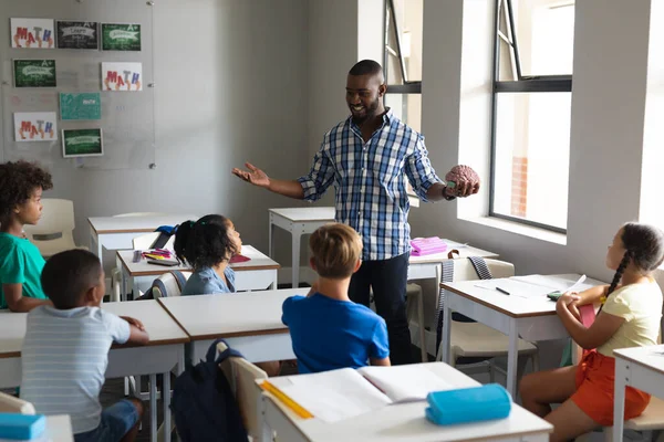 Usmívající Mladý Africký Učitel Ukazující Model Mozku Mnohonásobným Základním Studentům — Stock fotografie