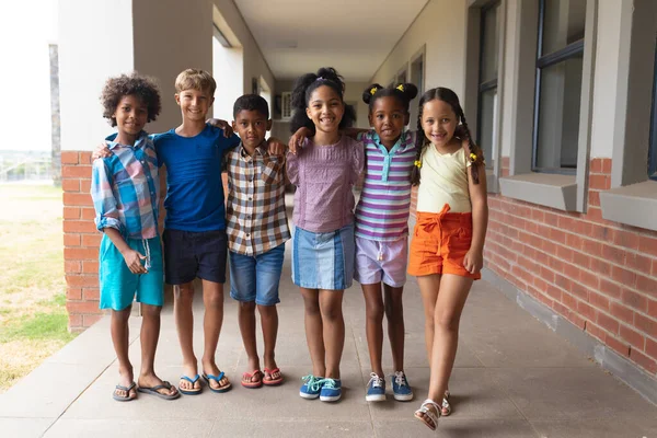 Portrait Smiling Multiracial Elementary School Students Arm Standing Corridor Unaltered — Stock Photo, Image