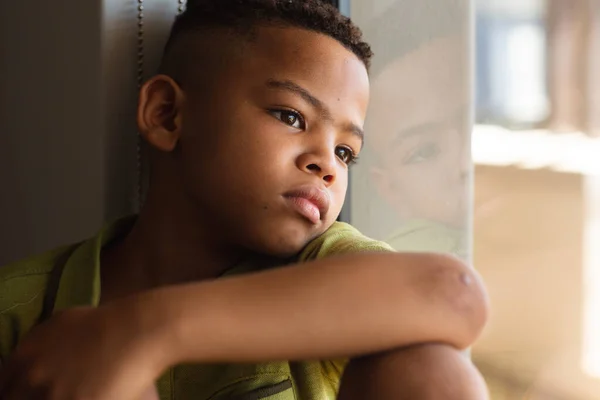 Close African American Elementary Schoolboy Looking Away While Sitting Window — Stock Photo, Image