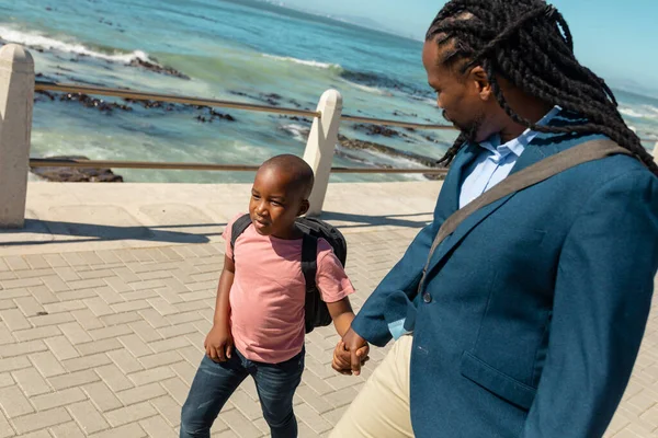 African American Father Looking While Holding Hand Son Walking Promenade — Photo