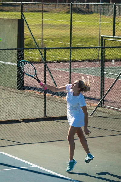 Full Length Young Female Caucasian Player Serving Tennis Ball Court — Stockfoto