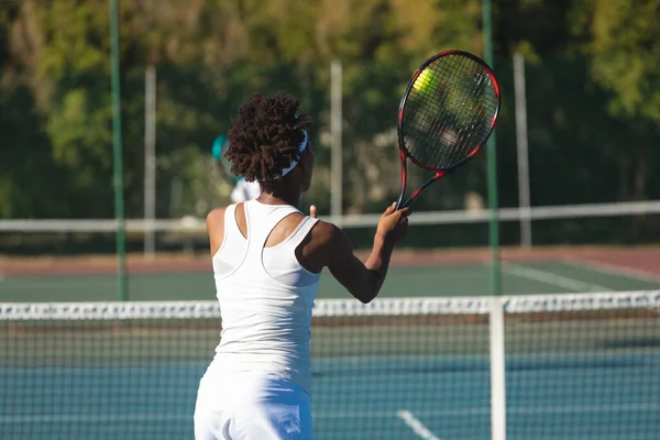 African American Female Player Hitting Ball Racket Tennis Court Sunny — Stockfoto