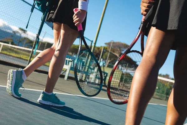 Low Section Female Tennis Players Walking Rackets Court Sunny Day — Fotografia de Stock