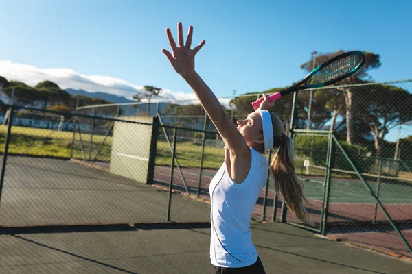 Side View Young Female Caucasian Player Serving Tennis Court Sunny — Stok fotoğraf