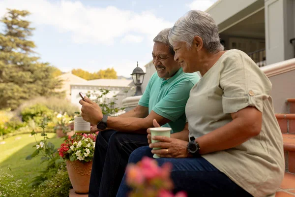 Smiling Biracial Senior Man Showing Digital Tablet Wife Holding Coffee — Photo