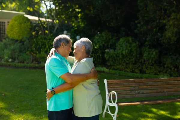 Happy Biracial Romantic Senior Couple Looking Each Other Embracing Plants — Fotografia de Stock