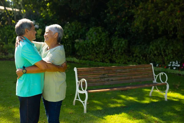 Smiling Biracial Senior Couple Looking Embracing While Standing Plants Park — Stock Photo, Image