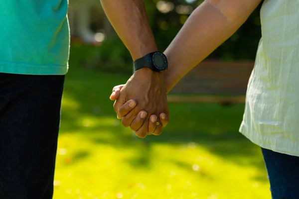 Midsection Biracial Senior Man Wearing Wristwatch Holding Wife Hand While — стоковое фото