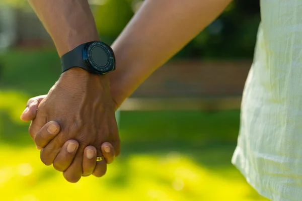 Cropped Image Man Wearing Wristwatch Holding Wife Hand Park Unaltered — Φωτογραφία Αρχείου