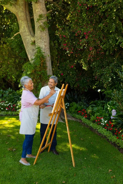 Biracial Senior Man Looking Happy Wife Painting Canvas While Standing — Stok fotoğraf