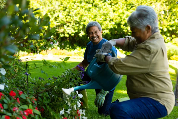 Smiling Biracial Senior Man Looking Senior Wife Watering Flowers Watering — ストック写真