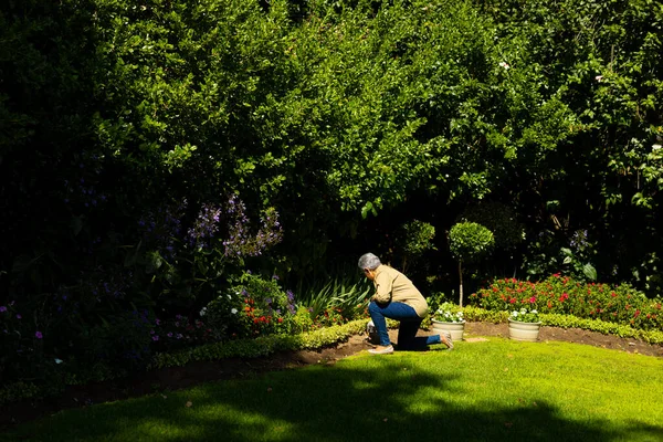 Side View Biracial Senior Woman Short Hair Gardening While Kneeling — Stockfoto