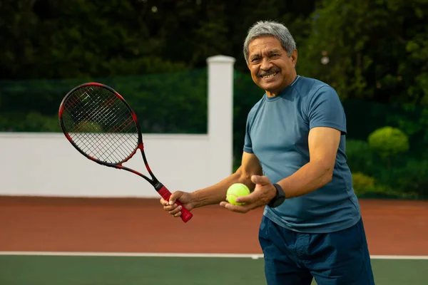 Portrait Smiling Biracial Senior Man Holding Tennis Ball Racket While — Stock Fotó