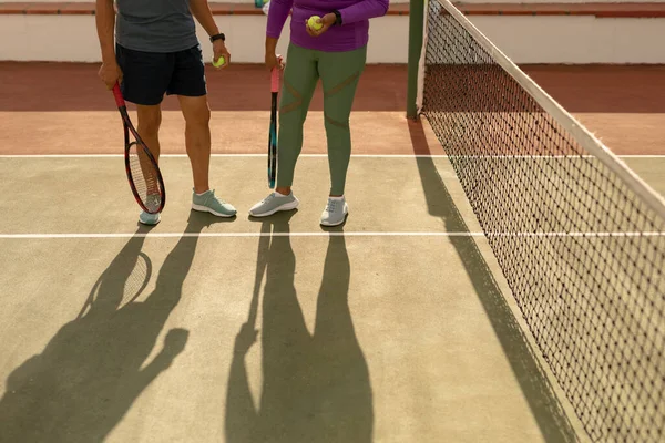 Low Section Couple Rackets Balls Standing Net Tennis Court Sunlight — Photo