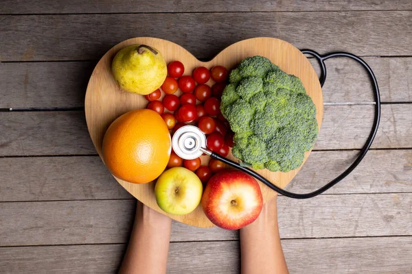 African American Mid Adult Woman Holding Heart Shape Vegetables Fruits — Foto de Stock